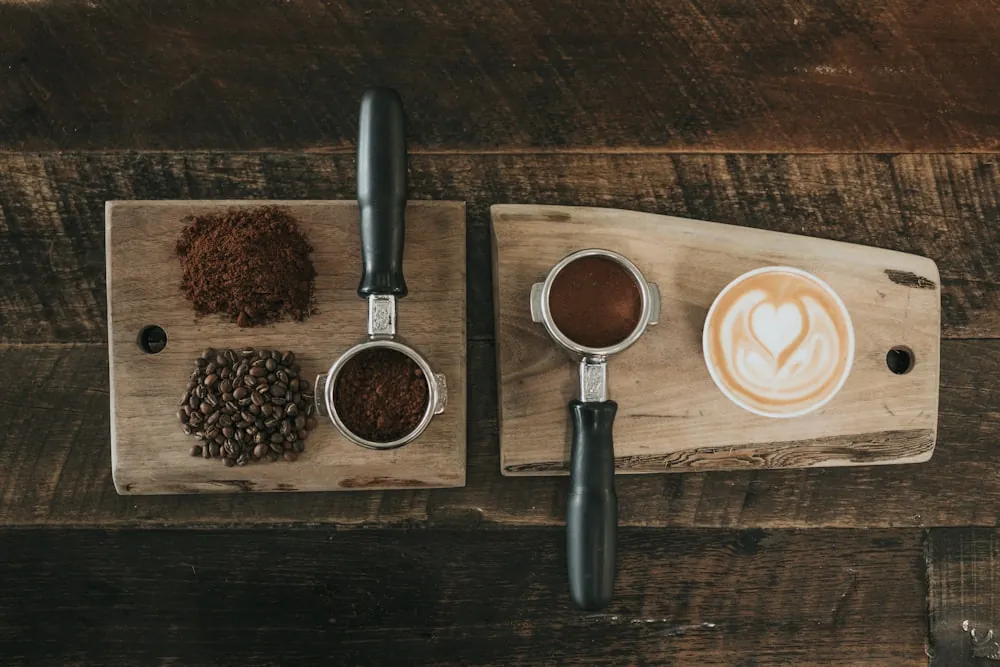 Coffee grounds, portafilters and a prepared latte
